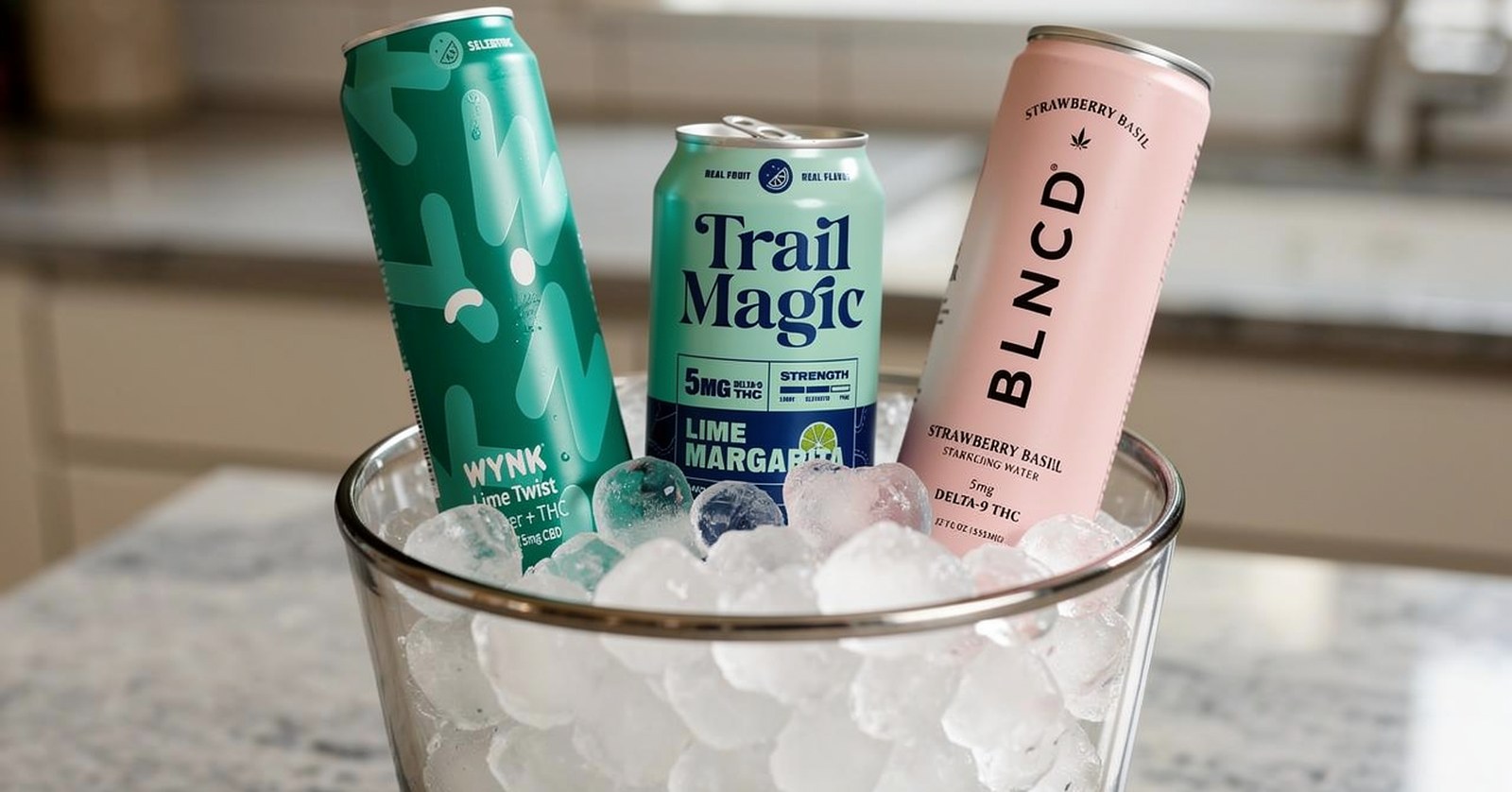 Wynk Lime Twist, Trail Magic Lime Margarita, and BLNCD Strawberry Basil cans chilling in a glass ice bowl