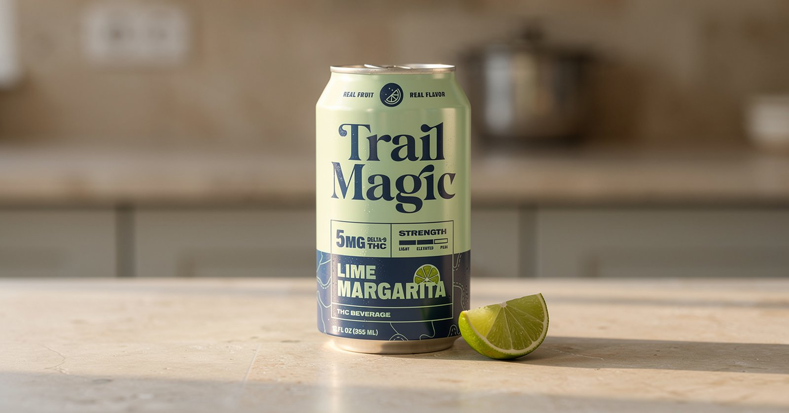Trail Magic Lime Margarita can on a kitchen counter next to a cut lime